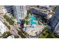 Aerial view of a community with a luxurious swimming pool and manicured landscaping at 1209 E Cumberland Ave # 508, Tampa, FL 33602