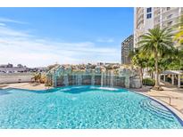 Resort-style pool with waterfall feature and palm trees at 1209 E Cumberland Ave # 508, Tampa, FL 33602
