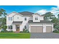 Two-story home with white siding, gray garage doors and landscaping at 3814 W Tacon St, Tampa, FL 33629