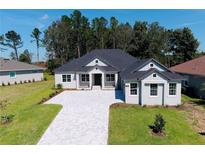 Two-story house with gray siding and paver driveway at 4748 Hickory Oak Dr, Brooksville, FL 34601