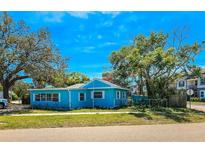 Charming corner lot home featuring a bright blue exterior and mature trees for shade and curb appeal at 527 4Th Nw Ave, Largo, FL 33770