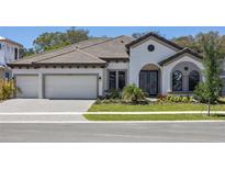 Charming single-story home with a three-car garage and well-manicured front yard at 12823 Daleridge Pl, Riverview, FL 33579