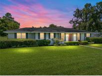 Ranch-style home with a spacious lawn and mature trees at 37232 Mcminn Ave, Dade City, FL 33525