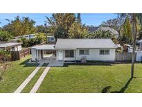 House with carport, driveway, and well-maintained lawn at 6611 14Th N St, St Petersburg, FL 33702