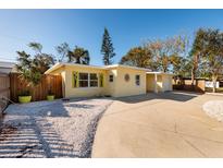 Charming yellow house with a landscaped yard and driveway at 6614 10Th Avenue S Ter, St Petersburg, FL 33707
