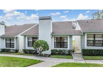 Inviting exterior of charming townhome with well-manicured landscaping at 3551 Magnolia Ridge Cir # 702, Palm Harbor, FL 34684