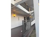 Stairwell leading to condo units with dark brown railings at 4774 Fox Hunt Dr # C115 &C113, Wesley Chapel, FL 33543