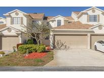 Two-story townhouse with attached garage and landscaping at 6400 46Th N Ave # 8, Kenneth City, FL 33709