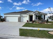 Beautiful two-car garage home with landscaping at 1027 Ocean Spray Dr, Ruskin, FL 33570