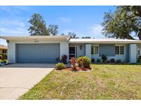 Charming single-story home with a well-maintained lawn and a blue exterior paint at 1467 Monte St, Port Charlotte, FL 33952
