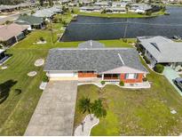 Aerial view of single-story home with waterfront access at 1705 Bryn Mawr Ave, Sun City Center, FL 33573