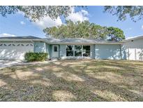 Light blue single story home with a two car garage at 3275 Fox Hill Dr, Clearwater, FL 33761