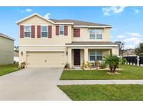 Two-story house with a two-car garage and a well-maintained lawn at 3128 S Northview Rd, Plant City, FL 33566