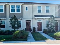 Two-story townhome with front yard and walkway at 11712 Stonesmith Xing, Palmetto, FL 34221