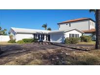 Ranch style home with attached garage at 10350 Paradise Blvd, Treasure Island, FL 33706
