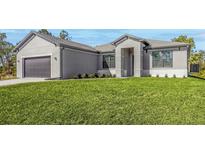Charming single-Gathering home featuring a well-manicured lawn and an attached two-car garage at 5227 Dayton Ln, Port Charlotte, FL 33981