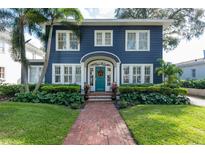 Two-story home with a teal front door and brick walkway at 2528 W Sunset Dr, Tampa, FL 33629