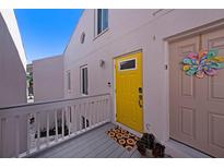 Exterior view showing a yellow front door and deck at 3120 Beach S Blvd # 7, Gulfport, FL 33707
