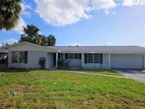 Ranch-style brick home with a spacious yard and attached garage at 4354 50Th S Ter, St Petersburg, FL 33711