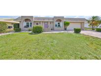 Well-maintained single-story home with a manicured lawn and neatly trimmed hedges at 1529 Allegheny Dr, Sun City Center, FL 33573