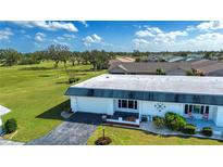 Single story home with a large yard and golf course views at 332 Club Manor Dr # 10, Sun City Center, FL 33573
