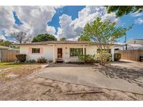 Charming single-story home with a well-manicured lawn and inviting curb appeal at 8950 3Rd N St, St Petersburg, FL 33702