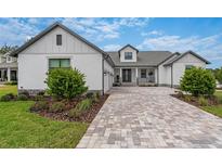 Craftsman style home with a paver driveway and landscaped front yard at 4187 Southern Valley Loop, Brooksville, FL 34601