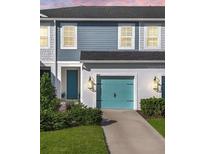 Charming two-story house with teal garage door and landscaping at 8607 Canyon Creek Trl, Parrish, FL 34219