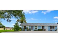 Charming single-story home featuring a blue exterior, well-maintained landscaping, and a welcoming entrance with a storm door at 3361 Scorecard Dr # 0, New Port Richey, FL 34655