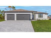 Charming single-Gathering home with a three-car garage and a well-manicured lawn at 4570 Gillot Blvd, Port Charlotte, FL 33981