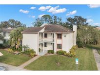 Two-story condo building with balcony and landscaping at 165 Lakeview Way # 165, Oldsmar, FL 34677