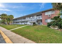 Brick apartment building with balconies, landscaping, and ample parking at 2353 Shelley St # 4, Clearwater, FL 33765