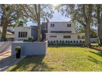 Modern home exterior with a landscaped yard and large trees at 838 Monterey Ne Blvd, St Petersburg, FL 33704