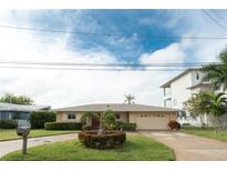 Single-story home with a carport and well-maintained lawn at 905 Oakwood Dr, Largo, FL 33770