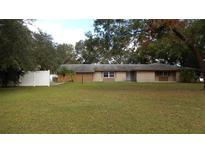 Ranch-style home with a spacious lawn and white fence at 3706 Joe Sanchez Rd, Plant City, FL 33565