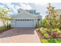 Two-story house with gray siding and brick driveway at 5625 Del Coronado Dr, Apollo Beach, FL 33572