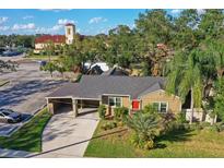 Aerial view of a charming house with a carport and neat landscaping at 3715 W Santiago St, Tampa, FL 33629