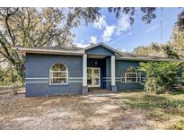 Single story home with front porch and mature trees at 6650 Horton Rd, Plant City, FL 33567