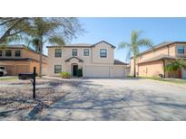 Two-story house with a two-car garage and a landscaped yard at 1708 Abbey Trace Dr, Dover, FL 33527