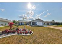 Charming single-story home with well-manicured lawn and colorful landscaping at 2019 N Pebble Beach Blvd, Sun City Center, FL 33573