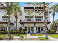 Charming townhouse exterior featuring a red tile roof and well-maintained landscaping at 403 S Oregon Ave, Tampa, FL 33606