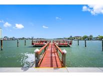Scenic view of the community dock with seating and calm waters on a sunny day at 6363 Gulf Winds Dr # 437, St Pete Beach, FL 33706