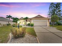 Inviting curb appeal with nicely landscaped yard and two-car garage at 719 Winterbrooke Way, Sun City Center, FL 33573