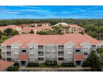 Aerial view of a multi-unit residential building with red tile roofs at 18001 Richmond Place Dr # 734, Tampa, FL 33647