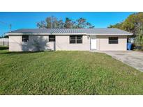 Newly renovated house with metal roof, fresh paint, and a spacious lawn at 309 12Th Sw St, Ruskin, FL 33570