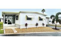 Mobile home with carport and landscaping at 9790 66Th N St # 208, Pinellas Park, FL 33782