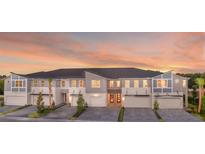 Modern townhouses with attached garages and sunset view at 4351 Cloud Hopper Way, Lutz, FL 33559