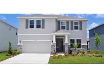 Charming two-story home with stone accents, neutral paint, manicured lawn, and two car garage at 16021` 7Th E Ave, Bradenton, FL 34212