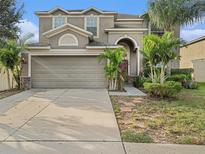 Two-story house with attached garage and landscaped front yard at 2411 Birds Eye Ct, Ruskin, FL 33570