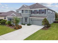 Charming two-story home featuring a well-maintained lawn and a spacious two-car garage at 6317 Brevada Ln, Apollo Beach, FL 33572